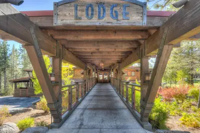 a wooden bridge with a sign that reads lodge at Kitzbuhel Paradise Sleeps 8 in Truckee