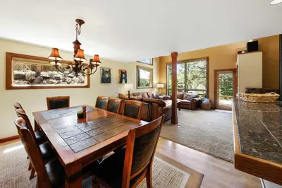 a dining room and living room with a table and chairs at Kitzbuhel Paradise Sleeps 8 in Truckee