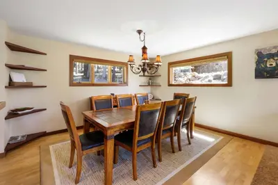 a dining room with a wooden table and chairs at Kitzbuhel Paradise Sleeps 8 in Truckee