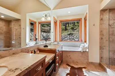 a bathroom with a sink and a tub and a shower at Luxury Mountain Chalet Deck w BBQ & Lake Views in Tahoe City