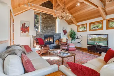 a living room with a couch and a fireplace at Luxury Mountain Chalet Deck w BBQ & Lake Views in Tahoe City