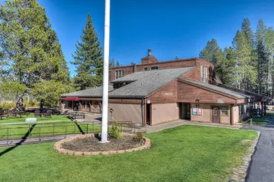an old building with a pole in the yard at Lux Leisure Game Room & More in Truckee