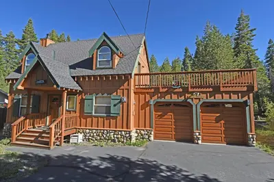 a large wooden house with a large deck at McKinney Estate w Roof Deck Beach & Hike in Tahoma