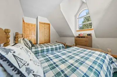 a bedroom with two beds and a window at McKinney Estate w Roof Deck Beach & Hike in Tahoma