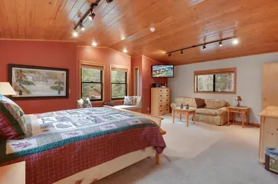 a bedroom with a bed and a living room at Lake Tahoe Treasure Minutes from Beach & Skiing in Tahoma