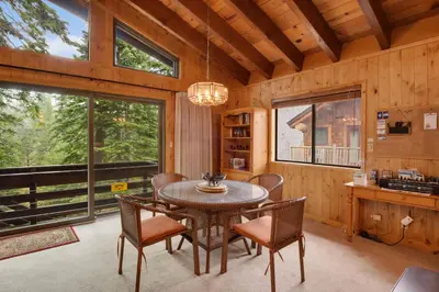 a dining room with a table and chairs and a large window at Lake Tahoe Treasure Minutes from Beach & Skiing in Tahoma