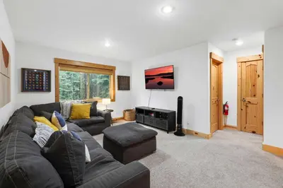 a living room with a couch and a tv at Modern Lake Tahoe Retreat Ski and Swim in Tahoe Vista