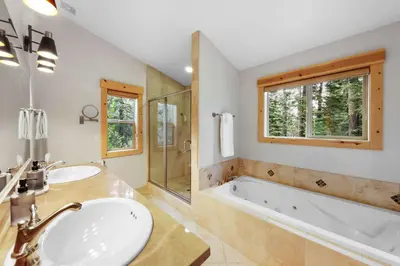 a bathroom with two sinks and a tub and a window at Modern Lake Tahoe Retreat Ski and Swim in Tahoe Vista