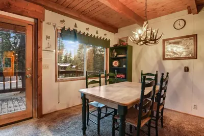 a dining room with a wooden table and chairs at Moose Cabin Year Round Outdoor Fun w BBQ in Carnelian Bay