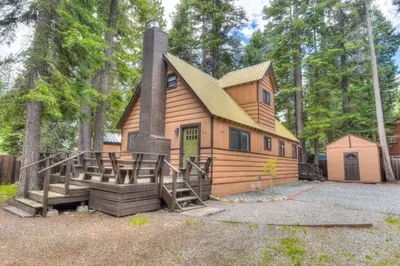 a wooden house with a chimney and a porch at Moose Manor w BBQ Near Tahoe Hiking in Tahoma