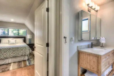 a bedroom with a bed and a sink and a mirror at Moose Manor w BBQ Near Tahoe Hiking in Tahoma