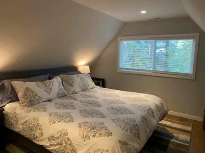 a bedroom with a large bed with a window at Moose Manor w BBQ Near Tahoe Hiking in Tahoma