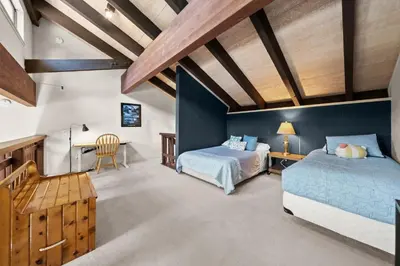 a bedroom with two beds and a desk at Mountain Shadows Chalet Tahoe Fun Awaits in Incline Village
