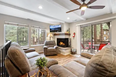 a living room with a couch and a fireplace at Family Fun Getaway - 3 Story Condo in Zephyr Cove