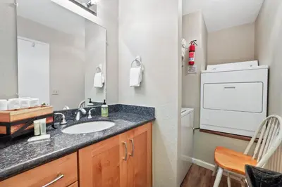 a bathroom with a sink and a washer and dryer at Family Fun Getaway - 3 Story Condo in Zephyr Cove