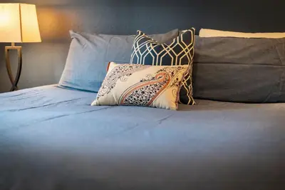 a bed with three pillows on top of it at Family Fun Getaway - 3 Story Condo in Zephyr Cove