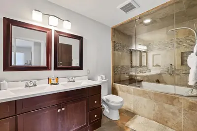 a bathroom with a sink and a toilet and a tub at Hall Court Manor - Hot tub Pet Friendly Pool Table in Stateline