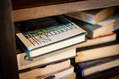 a stack of books sitting on a shelf at Heavenly Haven - Hot Tub and Seasonal HOA Pool in Zephyr Cove