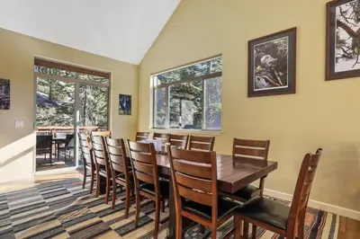 a dining room with a wooden table and chairs at Heavenly Mountain Chalet - Skiing Pets Hot tub in Stateline