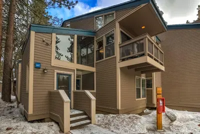 a house in the snow with a balcony at Lakeland Sandy Beach Retreat - Private Escape in South Lake Tahoe