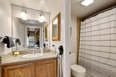a bathroom with a sink and a toilet at Lakeland Sandy Beach Retreat - Private Escape in South Lake Tahoe