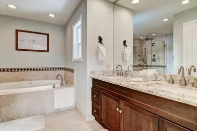 a bathroom with two sinks and a bath tub and a tubermott at Lucerne Lake House - Ski Lease 30plus Days in South Lake Tahoe