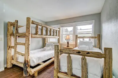 two bunk beds in a room with a window at Lucerne Lake House - Ski Lease 30plus Days in South Lake Tahoe