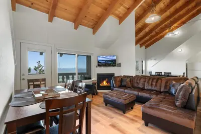a living room with a couch and a table at Mile High Mountain - Carson Valley Views in Stateline