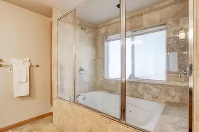 a bathroom with a tub and a glass shower at Montgomery Estates Bliss - Hot tub pets family fun in South Lake Tahoe