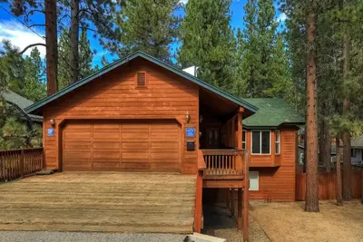 a house with a large wooden garage at Montgomery Estates Bliss - Hot tub pets family fun in South Lake Tahoe