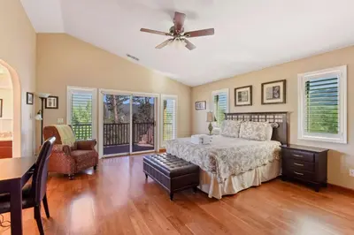 a bedroom with a bed and a ceiling fan at Mule Meadows - Classy Split level South Tahoe home in South Lake Tahoe