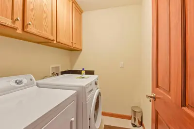a laundry room with a white washer and dryer at Mule Meadows - Classy Split level South Tahoe home in South Lake Tahoe