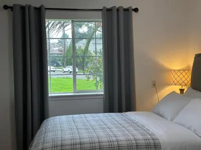 a bedroom with a bed and a window at Private Suites in Sacramento
