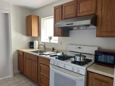a kitchen with a white stove and a sink at Private Suites in Sacramento