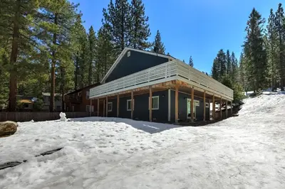 a house in the snow in the woods at Amachen Cabin - Pet & Family Friendly - woof woof in South Lake Tahoe