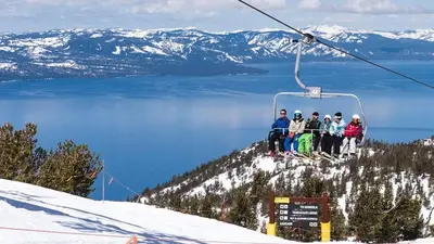 a group of people sitting on a ski lift at Badger Basin - 30 Days or more Vacation Home Rental in South Lake Tahoe