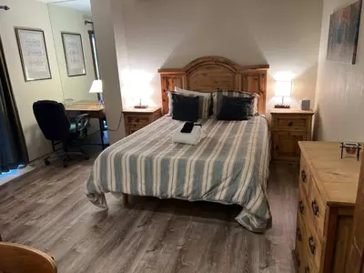 a bedroom with a bed with a laptop on it at Bear Haus - Fur babies welcome in South Lake Tahoe