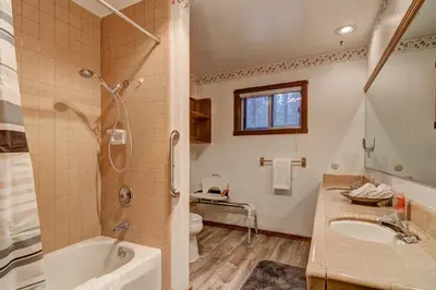 a bathroom with a tub and a toilet and a sink at Bear Haus - Fur babies welcome in South Lake Tahoe