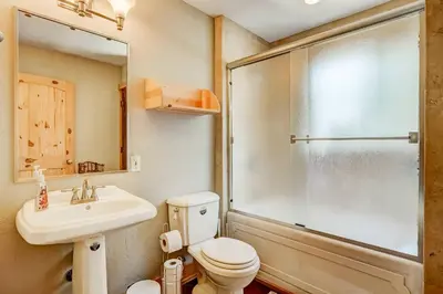 a bathroom with a shower and a toilet and a sink at Bear Pause 4BR - Large Deck & Balcony in South Lake Tahoe