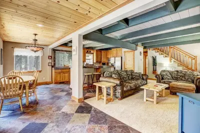 a living room with a couch and a table at Bear Pause 4BR - Large Deck & Balcony in South Lake Tahoe