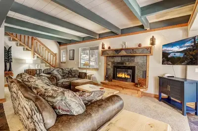 a living room with a couch and a fireplace at Bear Pause 4BR - Large Deck & Balcony in South Lake Tahoe