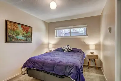 a bedroom with a purple bed and a window at Blue Black Bart - Foosball Near Town & More in South Lake Tahoe