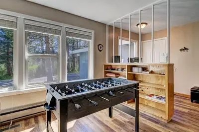a living room with a foosball table in the middle at Blue Black Bart - Foosball Near Town & More in South Lake Tahoe