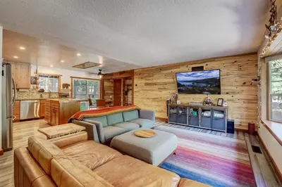 a living room with a couch and a tv at The Blue Lake House - Family fun Abound in South Lake Tahoe
