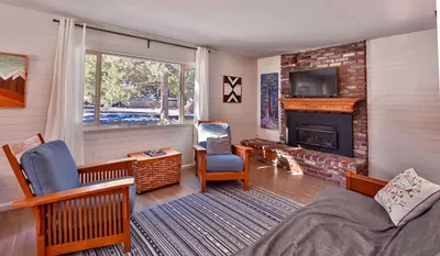 a living room with a fireplace and a tv at Charming Cherokee Cabin - Secluded Stay for 6 Just 10 Minutes to Tahoe in South Lake Tahoe