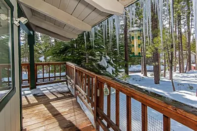 a wooden deck with a view of the woods at Cherry Hills Cabin - Sleeps 6 No Pets Family Fun in South Lake Tahoe