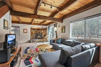 a living room with a couch and a fireplace at Christmas Valley Chalet - Tahoe Adventure Awaits in South Lake Tahoe