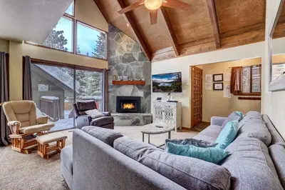 a living room with a couch and a fireplace at Cold Creek Chalet - Hot tub & Movie Room in South Lake Tahoe