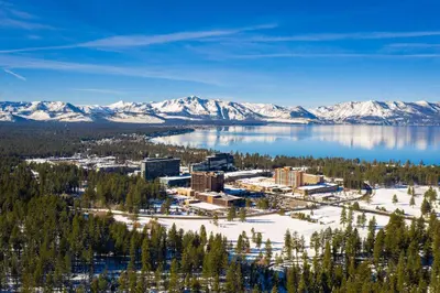 an aerial view of a resort on a lake with snow covered mountains at Ski In Ski Out 3 BDR Steps from Stagecoach Lift in Stateline