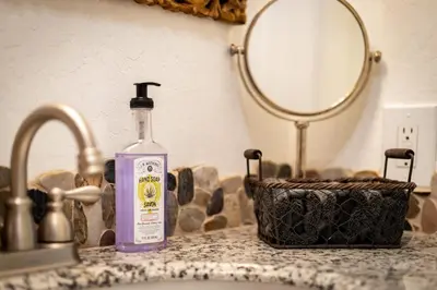 a bottle of gin sitting on a counter next to a sink at Coziness Cabin - Cute little cabin in the Tahoe woods in South Lake Tahoe